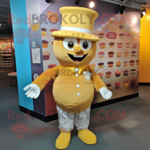 Gold Cupcake mascot costume character dressed with a Button-Up Shirt and Hat pins