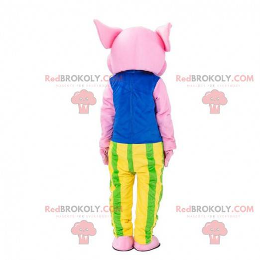 Rosa Schweinemaskottchen gekleidet in einem bunten Outfit -