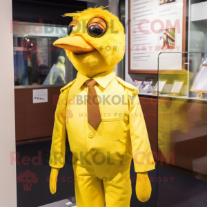 Gold Canary mascot costume character dressed with a Poplin Shirt and Suspenders