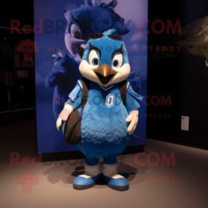 Blue Blue Jay mascot costume character dressed with a Rugby Shirt and Backpacks