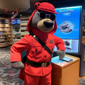 Red Navy Seal mascot costume character dressed with a Dress Shirt and Messenger bags