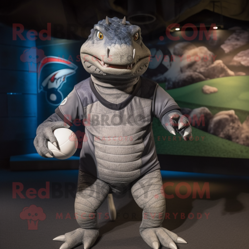 Gray Komodo Dragon mascot costume character dressed with a Rugby Shirt and Caps Gray Komodo Dragon mascot costume character dressed with a Rugby Shirt and Caps