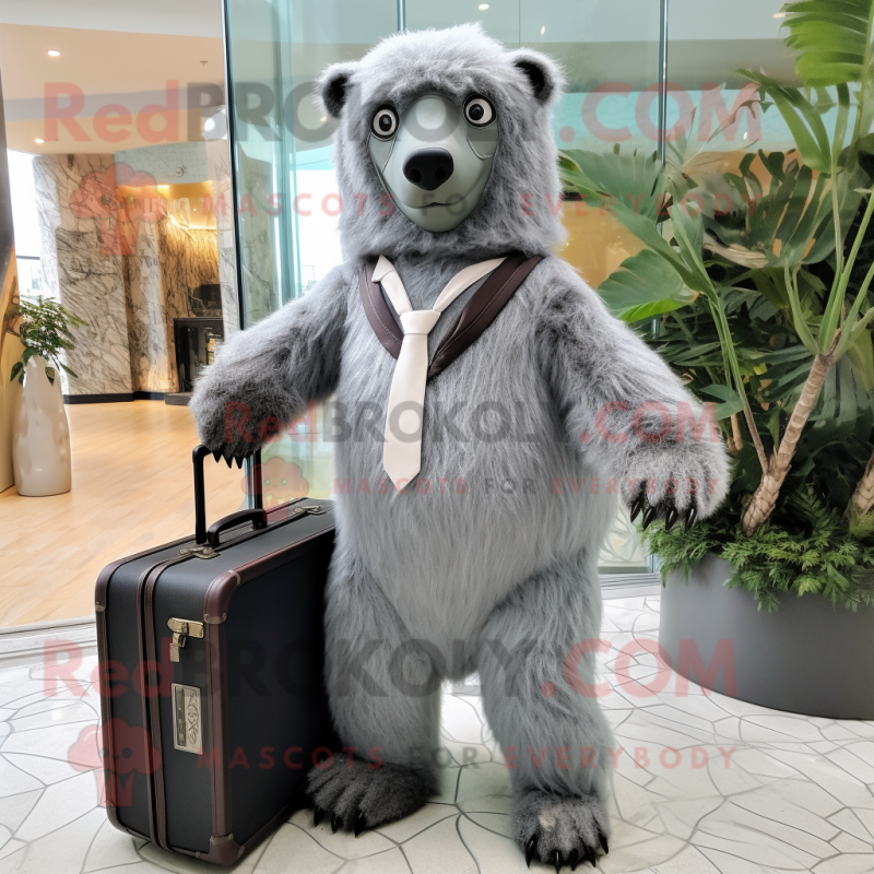 Silver Sloth Bear mascot costume character dressed with a A-Line Dress and Briefcases Silver Sloth Bear mascot costume character dressed with a A-Line Dress and Briefcases