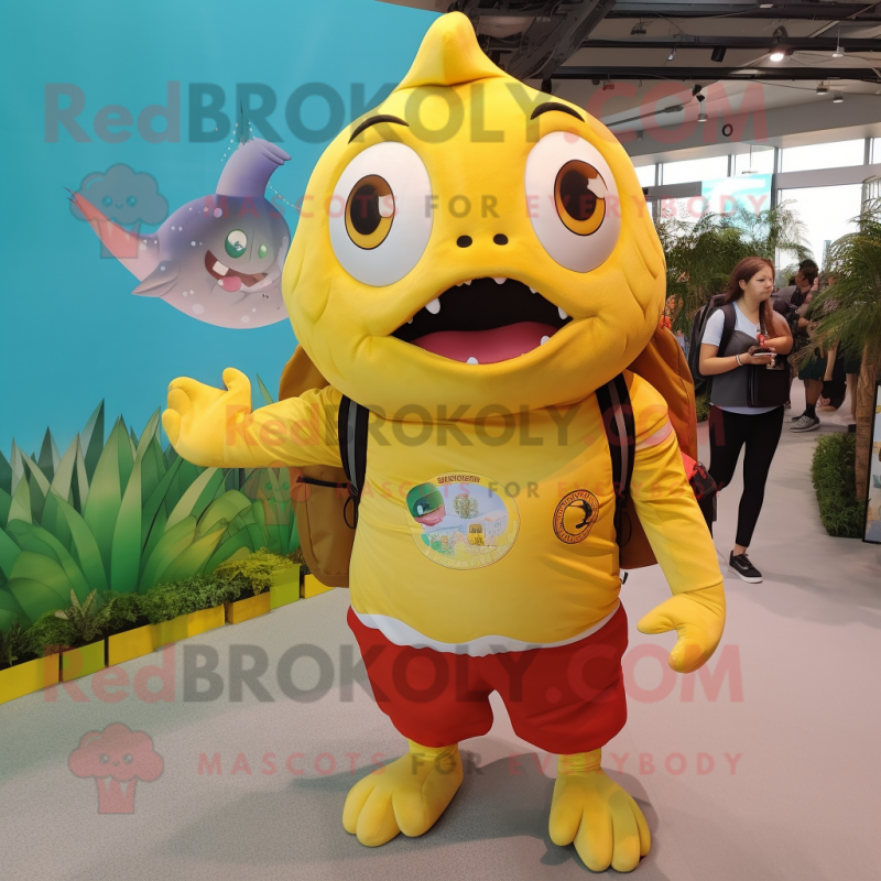 Yellow Piranha mascot costume character dressed with a Poplin Shirt and Backpacks