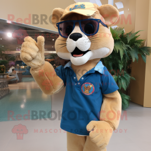 Tan Mountain Lion mascot costume character dressed with a Denim Shorts and Reading glasses