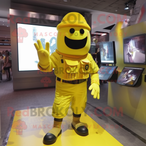 Yellow Soldier mascot costume character dressed with a Graphic Tee and Digital watches