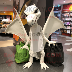 White Pterodactyl mascot costume character dressed with a Long Sleeve Tee and Tote bags