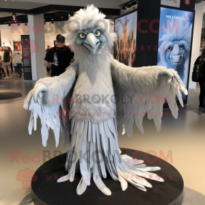 Silver Harpy mascot costume character dressed with a Maxi Dress and Shawl pins