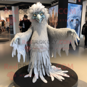 Silver Harpy mascot costume character dressed with a Maxi Dress and Shawl pins