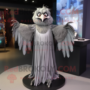 Silver Harpy mascot costume character dressed with a Maxi Dress and Shawl pins