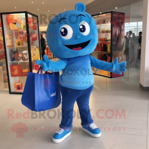 Blue Candy mascot costume character dressed with a Jeggings and Tote bags