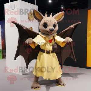 Gold Fruit Bat mascot costume character dressed with a Wrap Skirt and Suspenders