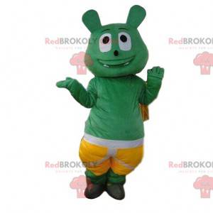 Mascota monstruo verde con pantalones cortos, traje de criatura