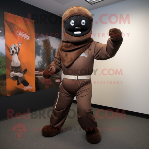 Brown Knife Thrower mascot costume character dressed with a Jumpsuit and Scarves