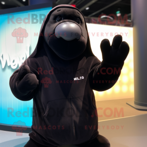 Black Walrus mascot costume character dressed with a Hoodie and Mittens