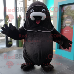 Black Walrus mascot costume character dressed with a Hoodie and Mittens