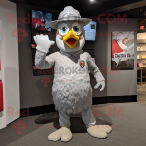 Silver Chicken mascot costume character dressed with a Graphic Tee and Hat pins