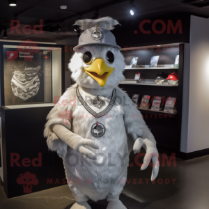 Silver Chicken mascot costume character dressed with a Graphic Tee and Hat pins