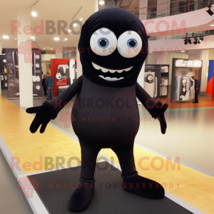 Black Cyclops mascot costume character dressed with a Poplin Shirt and Shoe laces