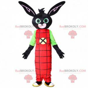 Mascotte de lapin noir avec une combinaison rouge, peluche