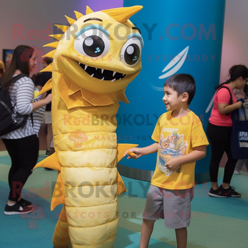 Gold Barracuda mascot costume character dressed with a Graphic Tee and Watches