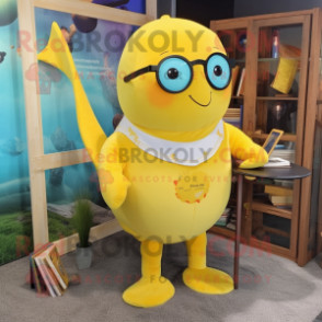 Yellow Narwhal mascot costume character dressed with a Romper and Reading glasses