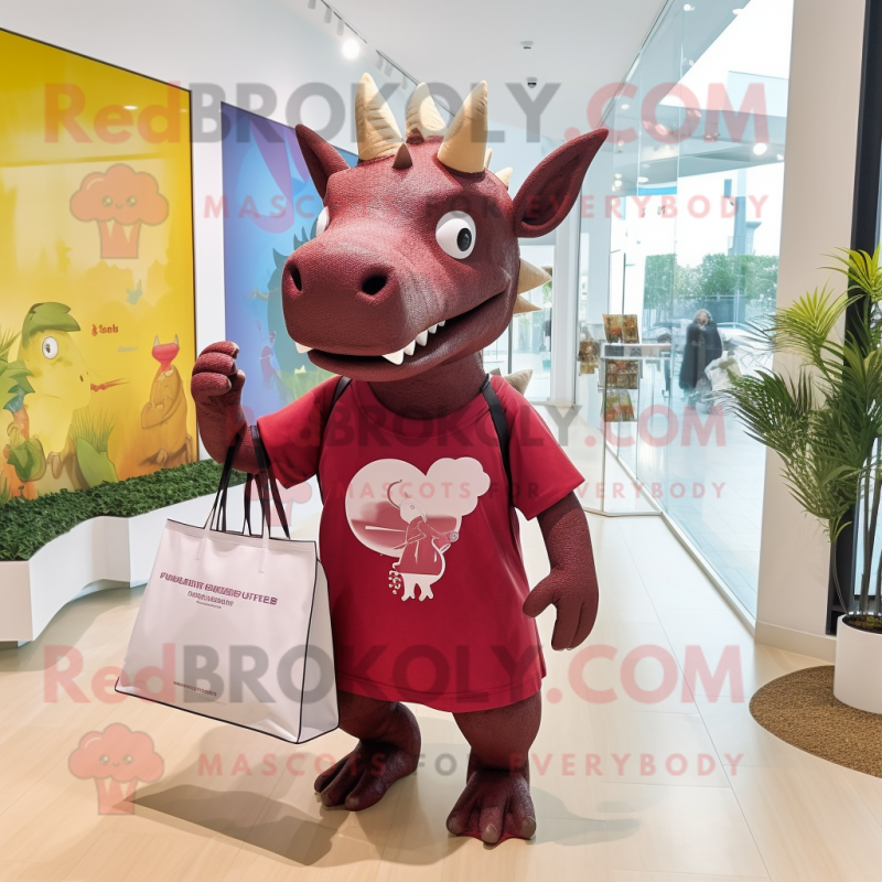 Maroon Triceratops mascot costume character dressed with a Romper and Tote bags Maroon Triceratops mascot costume character dressed with a Romper and Tote bags