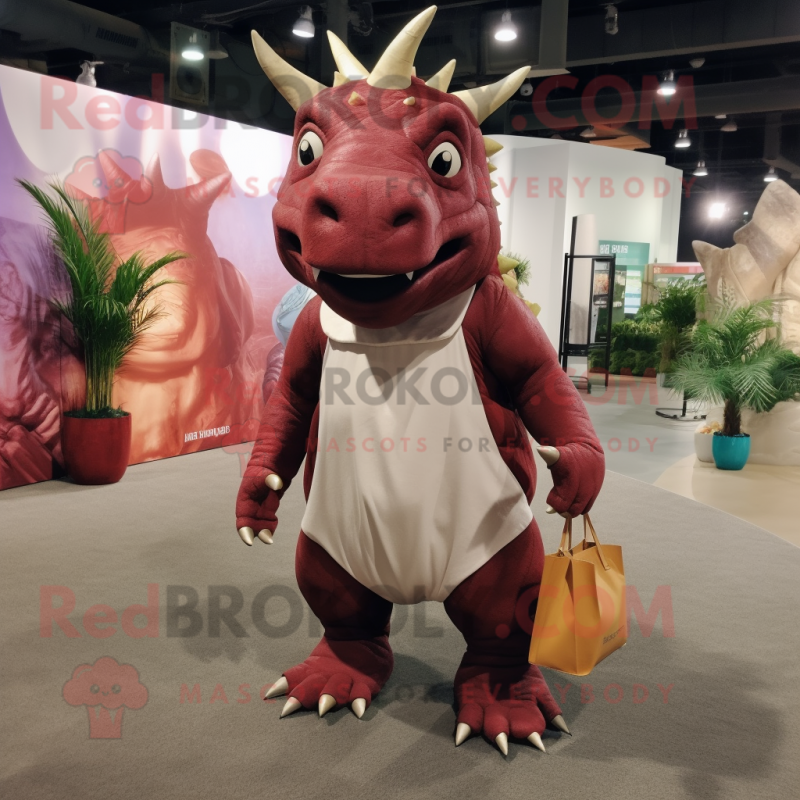 Maroon Triceratops mascot costume character dressed with a Romper and Tote bags