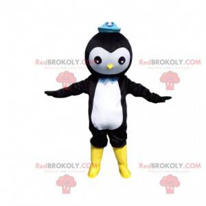 Mascota de pingüino blanco y negro con un sombrero azul -