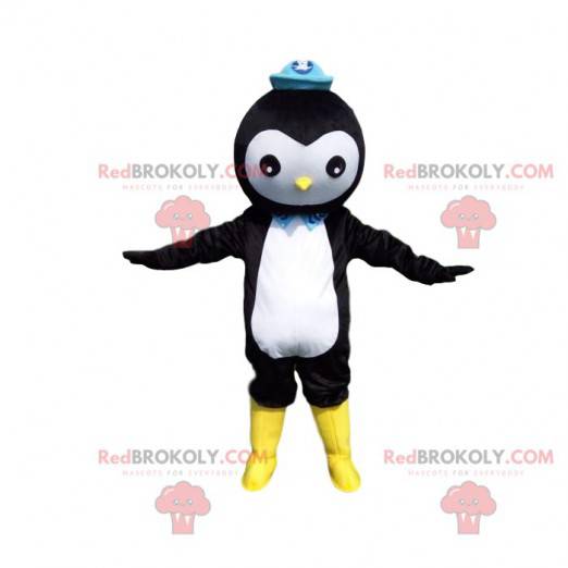 Mascotte de pingouin noir et blanc avec un chapeau bleu -