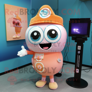 Peach Camera mascot costume character dressed with a Graphic Tee and Lapel pins
