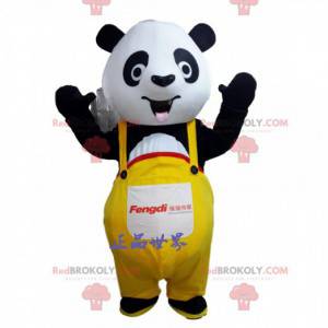 Mascote panda preto e branco com macacão amarelo -