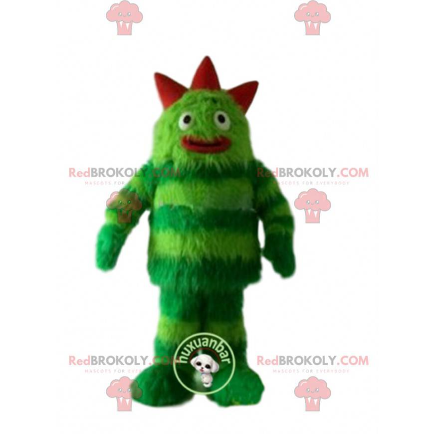 Monstro de mascote verde, cabeludo e divertido. Terno verde -
