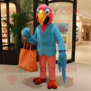 Peach Macaw mascot costume character dressed with a Suit Pants and Tote bags