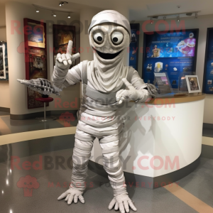 Silver Mummy mascot costume character dressed with a Capri Pants and Mittens