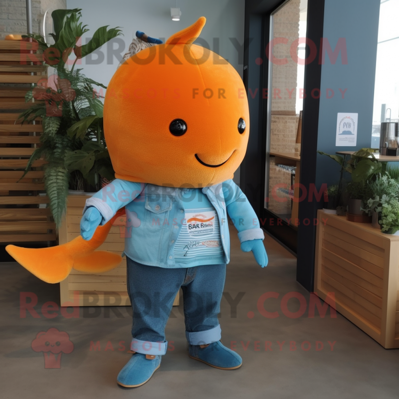 Orange Narwhal mascot costume character dressed with a Denim Shirt and Shoe clips