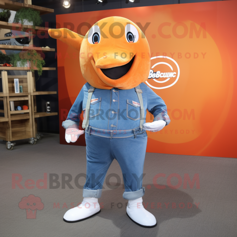 Orange Narwhal mascot costume character dressed with a Denim Shirt and Shoe clips