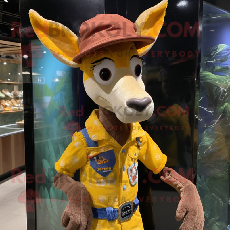 Yellow Okapi mascot costume character dressed with a Denim Shorts and Hat pins Yellow Okapi mascot costume character dressed with a Denim Shorts and Hat pins