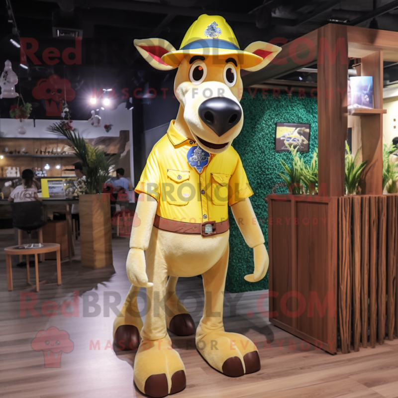 Yellow Okapi mascot costume character dressed with a Denim Shorts and Hat pins