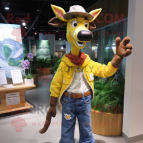 Yellow Okapi mascot costume character dressed with a Denim Shorts and Hat pins