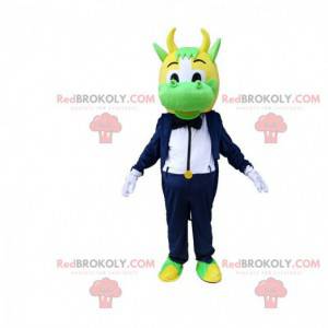 Mascotte mucca verde e gialla vestita in smoking elegante -