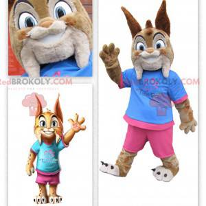 Mascot lindo lince vestida de rosa y azul - Redbrokoly.com