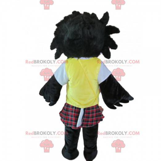 Mascot pájaro negro despeinado con una falda escocesa y un