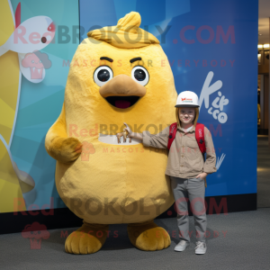 Gold Kiwi mascot costume character dressed with a Boyfriend Jeans and Suspenders