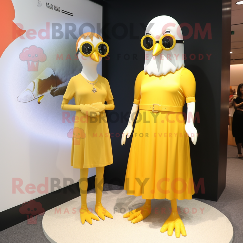 Gold Gull mascot costume character dressed with a Mini Dress and Eyeglasses Gold Gull mascot costume character dressed with a Mini Dress and Eyeglasses