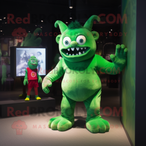 Grøn Dæmon maskot kostume karakter klædt med en Playsuit og ure