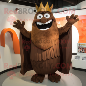 Brown King mascot costume character dressed with a Suit Pants and Shawl pins