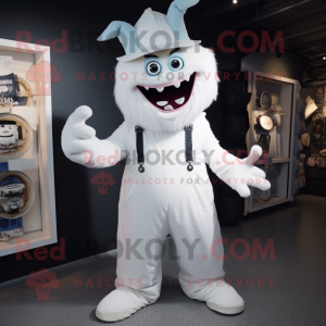 White Demon mascot costume character dressed with a Dungarees and Hat pins