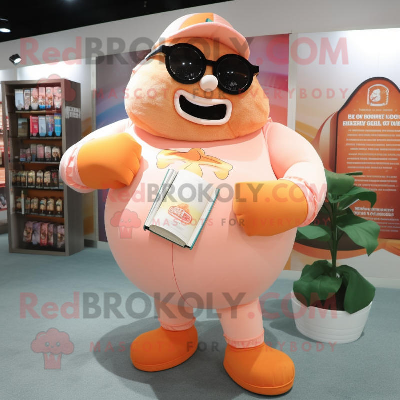 Peach Strongman mascot costume character dressed with a Cover-up and Reading glasses Peach Strongman mascot costume character dressed with a Cover-up and Reading glasses