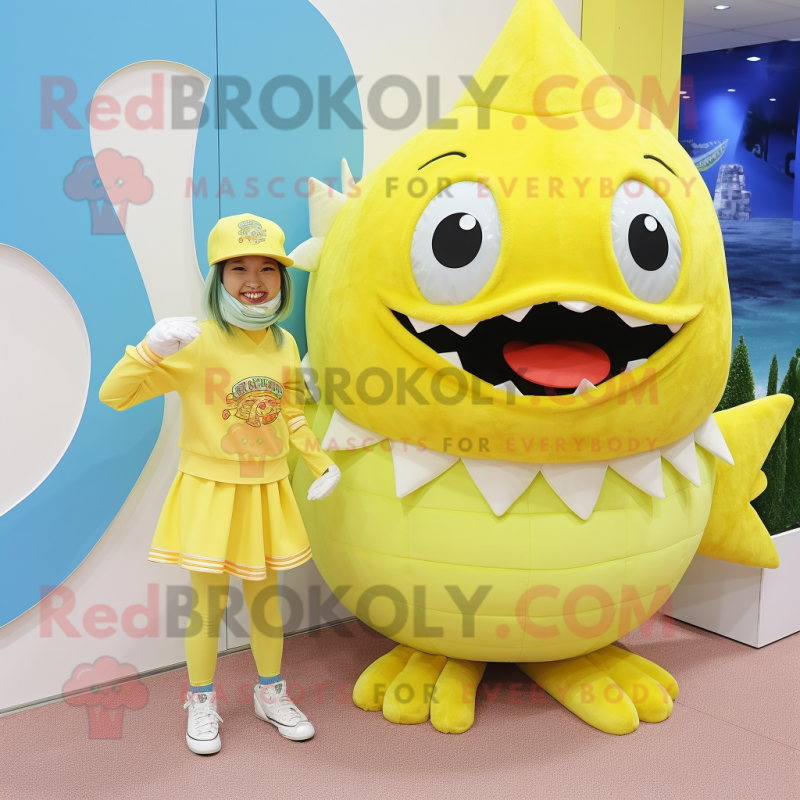 Lemon Yellow Piranha mascot costume character dressed with a Mini Dress and Beanies Lemon Yellow Piranha mascot costume character dressed with a Mini Dress and Beanies